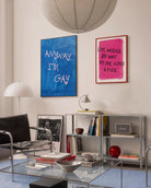 A poster with the text 'ANYWAY, I'M GAY' in pink, against a blue abstract background.