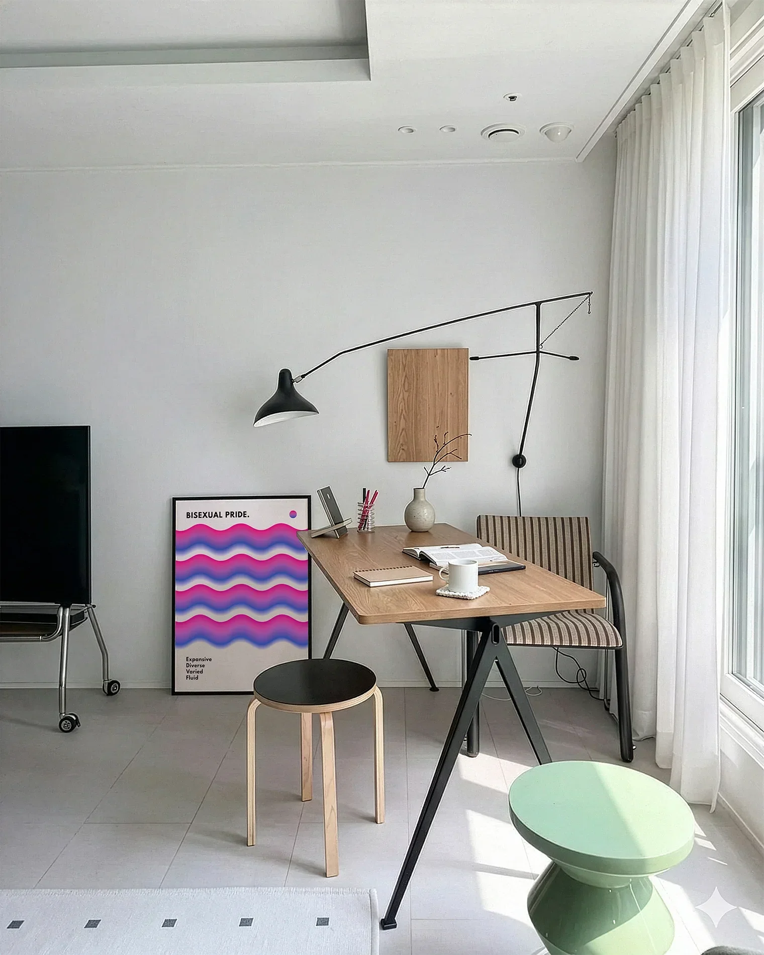 A framed bisexual pride poster in an office.