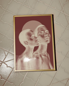 The poster depicts two naked, black women in a romantic pose in a negative color scale.