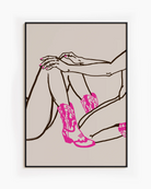 A poster with two naked cowgirls in pink boots.
