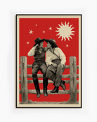 A framed poster with two lesbian cowgirls, sitting on a wooden fence, talking and flirting.