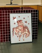 A poster with two lesbian cowgirls riding on a horse together.