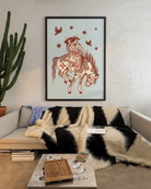 A poster with two lesbian cowgirls riding on a horse together.