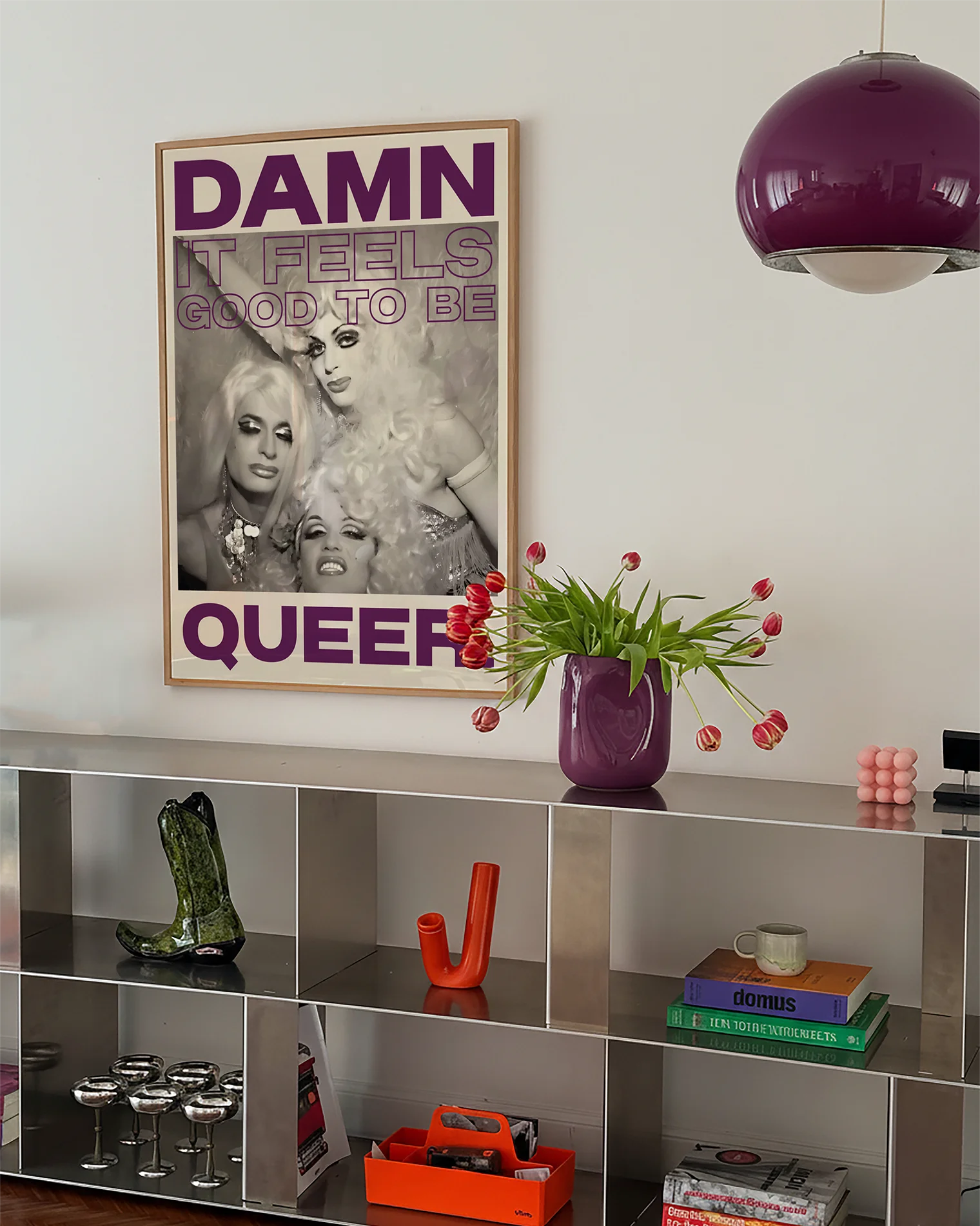 Postern föreställer tre dragqueens i en vintage fotografi-stil med texten ' DAMN IT FEELS GOOD TO BE QUEER.'