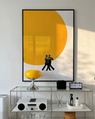 A poster of two men dancing in front of a big, yellow sun.