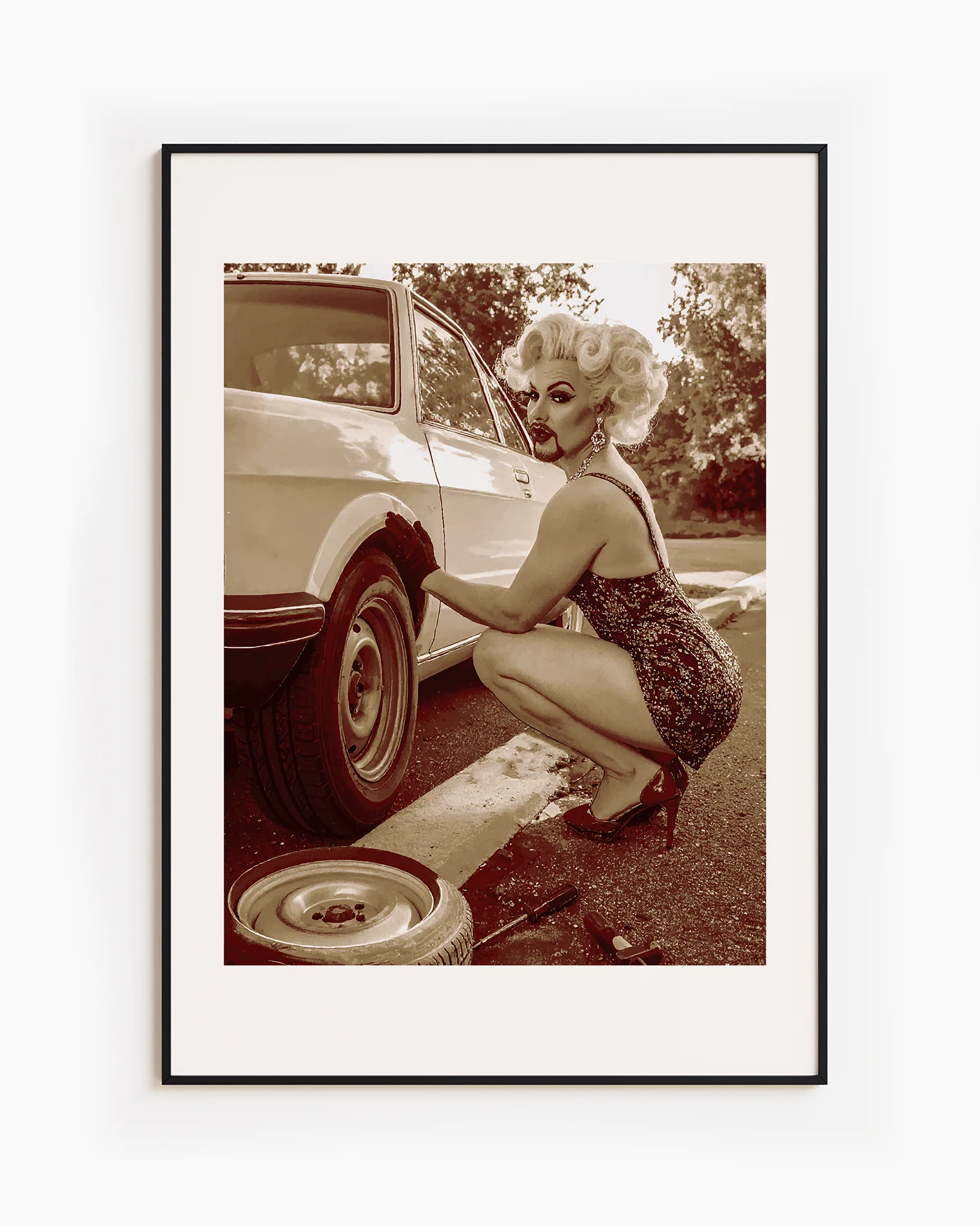 A poster featuring a fabulous drag queen in a sparkly dress, big wig, and dramatic makeup — right in the middle of a tire change.