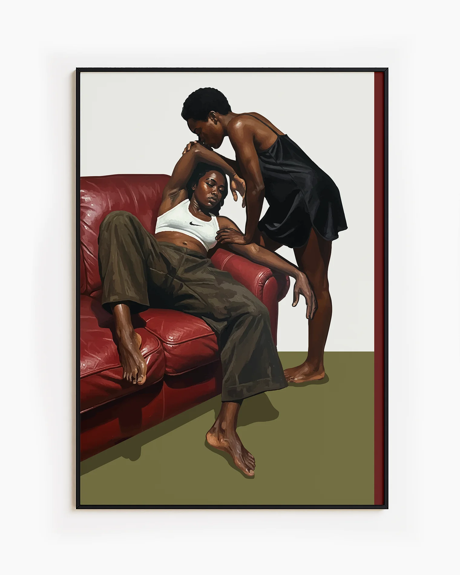 A framed poster with a black, lesbian couple kissing.