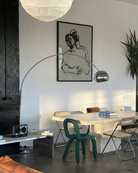 A framed poster with two, sketched gay men embracing in a dramatic pose.