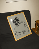 A framed poster with two, sketched gay men embracing in a dramatic pose.