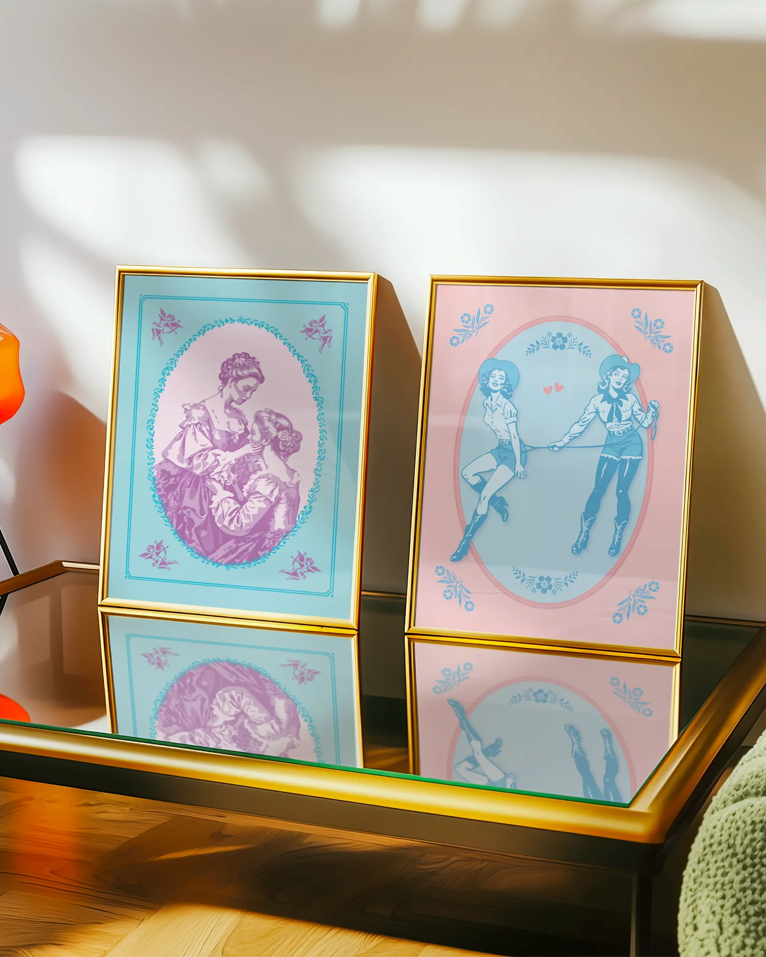 A gallery wall with two sapphic themed prints.