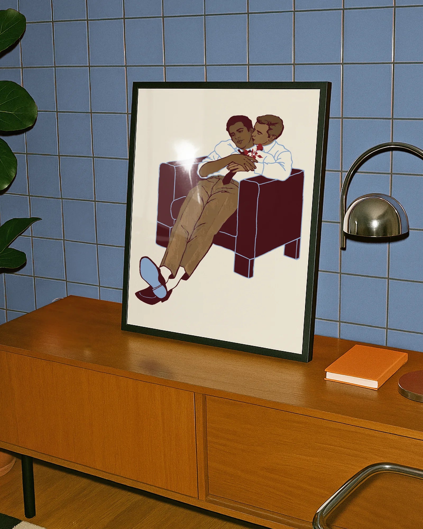 A framed poster with two gay men hugging.