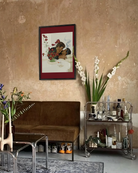 A framed print with two gentlemen in suits kissing on a couch, 1940's vintage style.