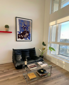 A framed poster with two, older men kissing on a couch.