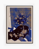 A framed poster with two, older men kissing on a couch.