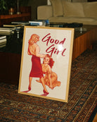 The poster depicting a woman standing in front of her lover, who kneels and looks up at her with a smile, accompanied by the text 'Good Girl'.