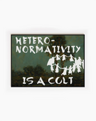 A framed poster depicting a group of people dancing in a cult-like circle, accompanied by the text “Heteronormativity Is a Cult.”
