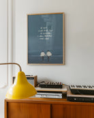 En poster som föreställer två män som springer hand i hand mot havet med texten 'IF MY LOVE FOR YOU IS ILLEGAL, I WILL BREAK THE LAW'.