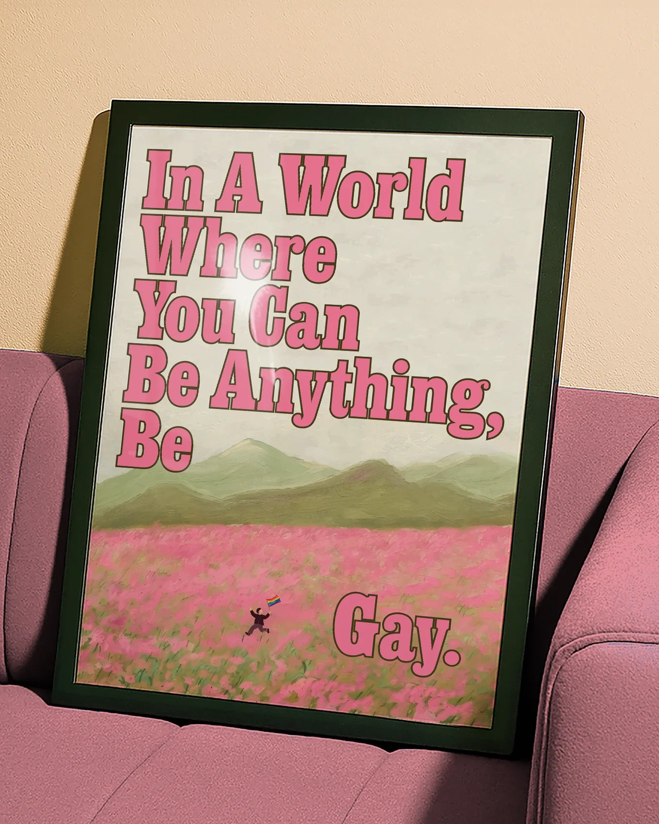 A poster of a person running through an open field of pink flowers, with a pride flag and the text: 'In a world where you can be anything, be gay'.
