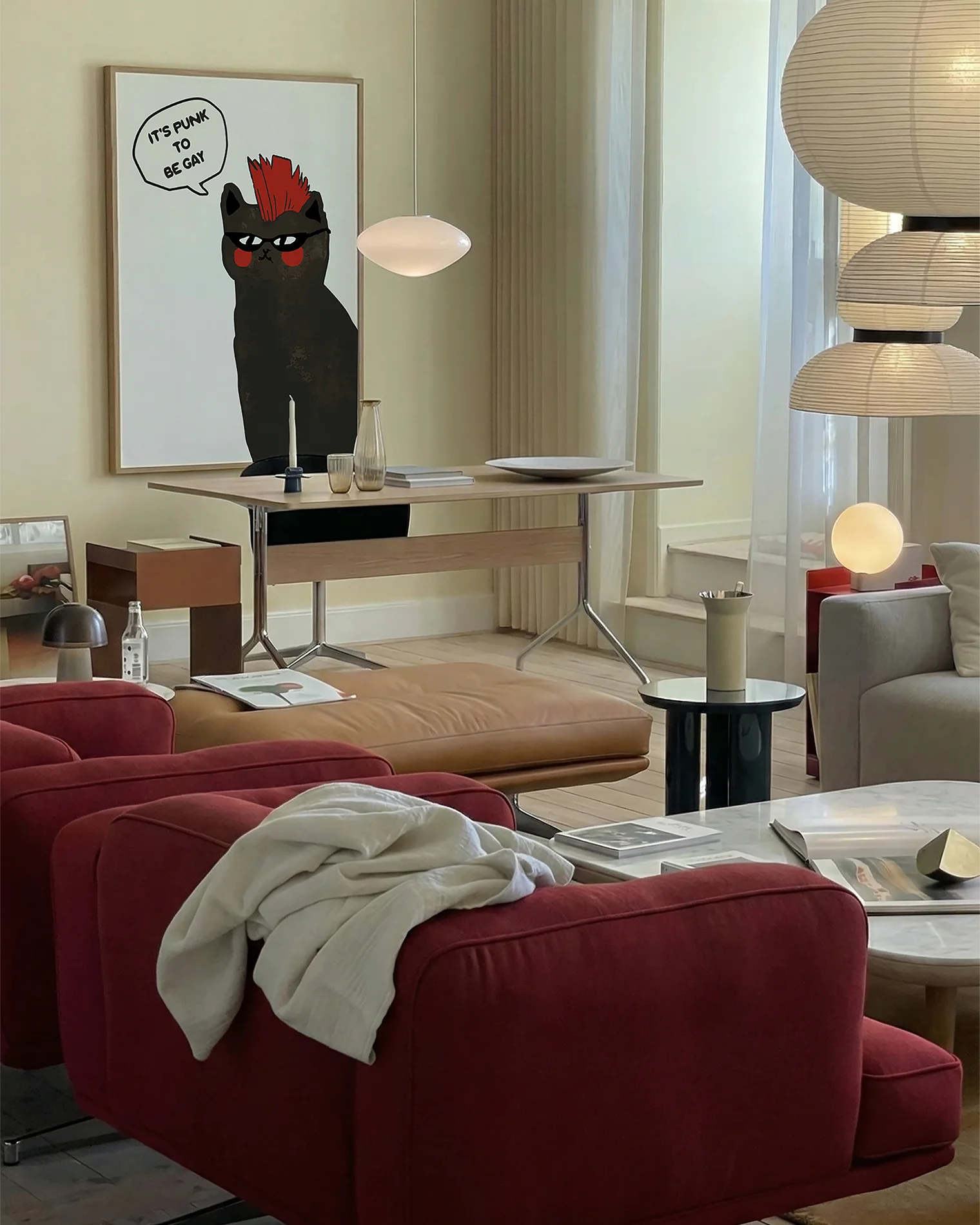 A framed print with a black, punk cat with the text 'It's punk to be gay'.