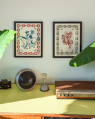 A framed poster featuring two cowgirls riding a horse, surrounded by a retro-style floral frame.