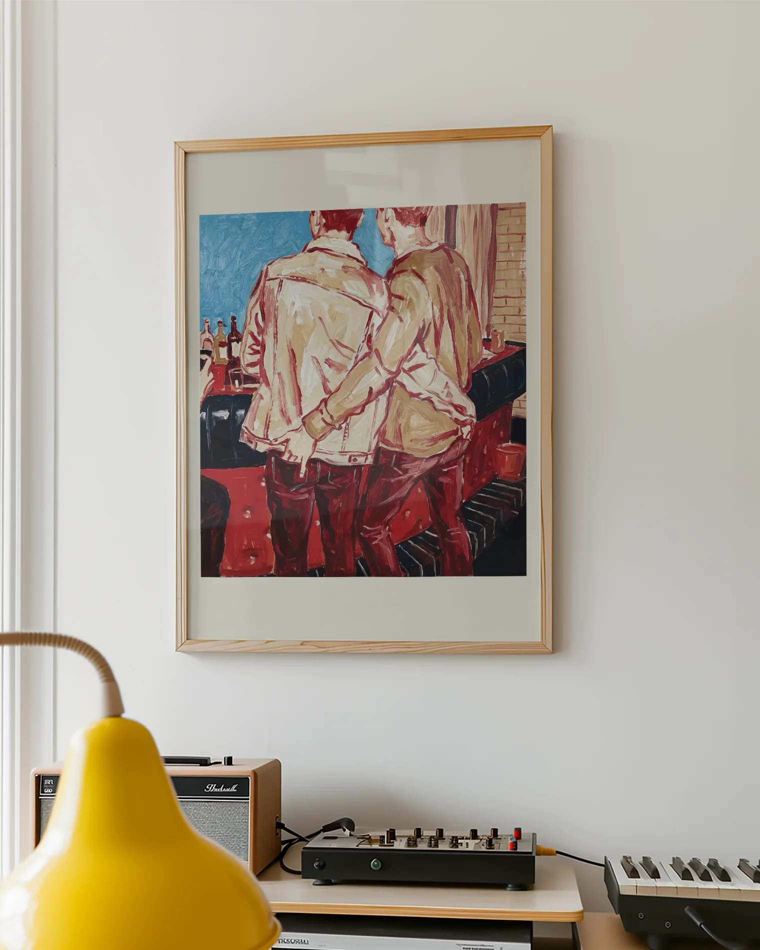 A framed poster with two gay men in a bar, ordering a drink with their hand in each other's backpockets.