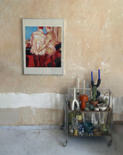 A framed poster with two gay men in a bar, ordering a drink with their hand in each other's backpockets.