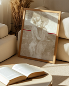 A framed poster with a lesbian, naked couple, abstract painting style.