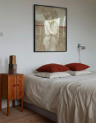 A framed poster with a lesbian, naked couple, abstract painting style.