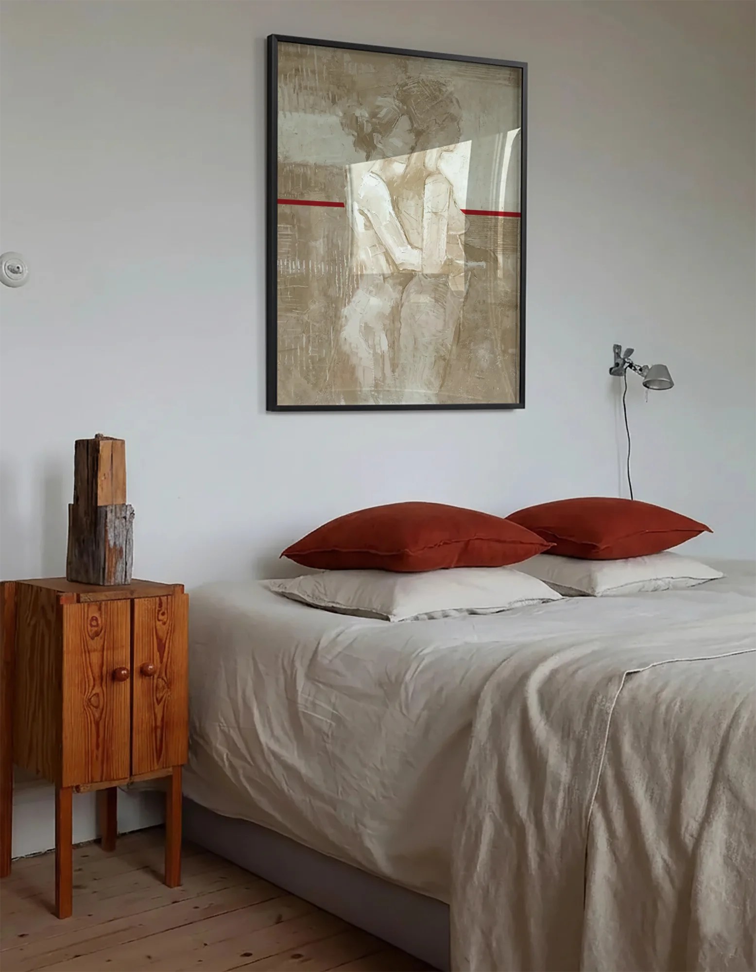 A framed poster with a lesbian, naked couple, abstract painting style.