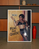 A framed poster with a black drag queen standing in front of a wall with a sign 'MEN ONLY', smiling.