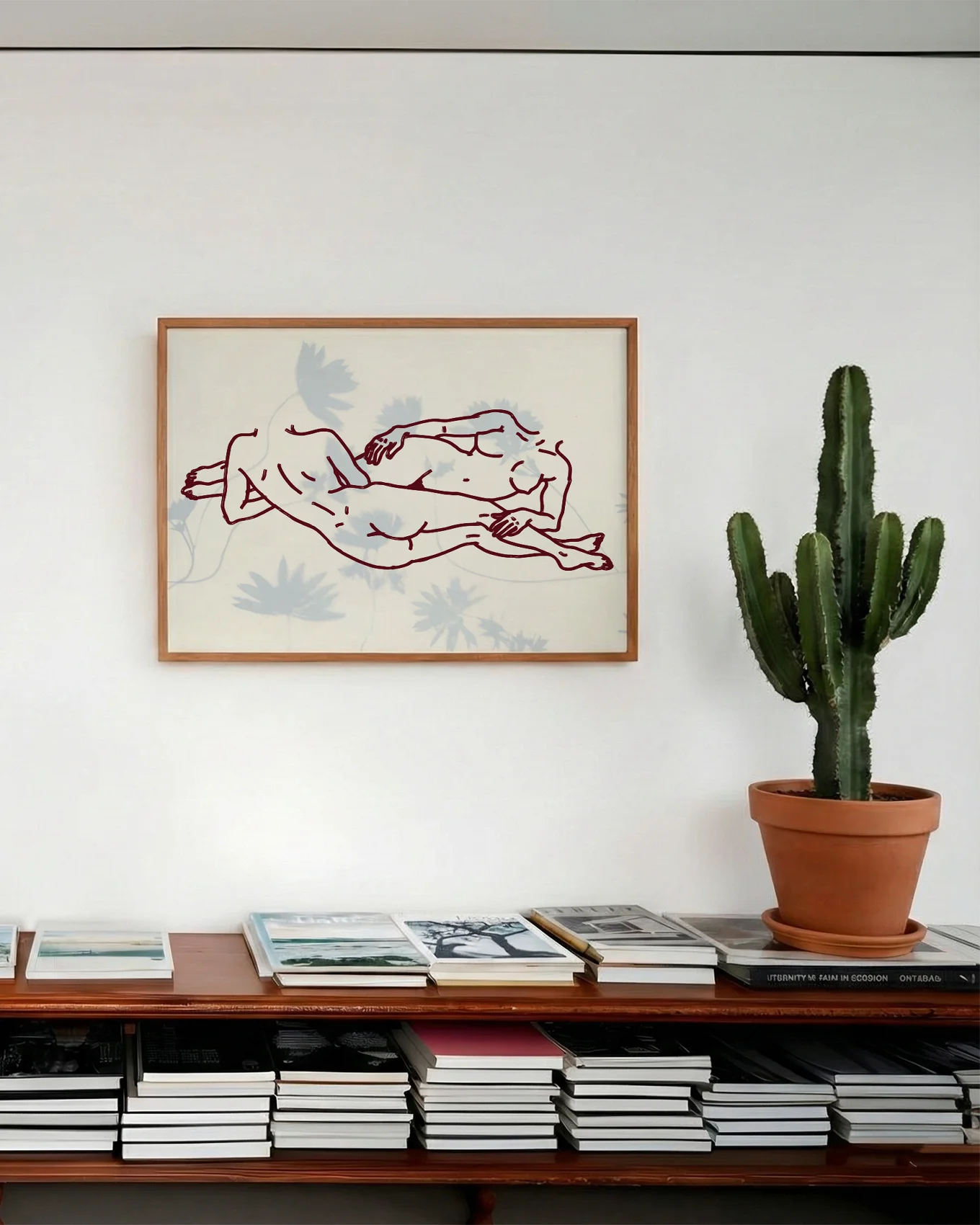 A framed poster with two lesbian girls laying down.