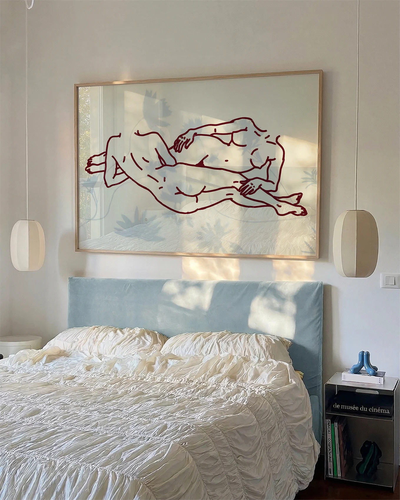 A framed poster with two lesbian girls laying down.