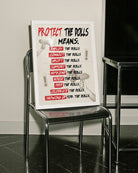 A framed print featuring the text “PROTECT THE DOLLS MEANS:” followed by:
employ the dolls
connect the dolls
uplift the dolls
support the dolls
befriend the dolls
house the dolls
feed the dolls
celebrate the dolls
showing up for the dolls