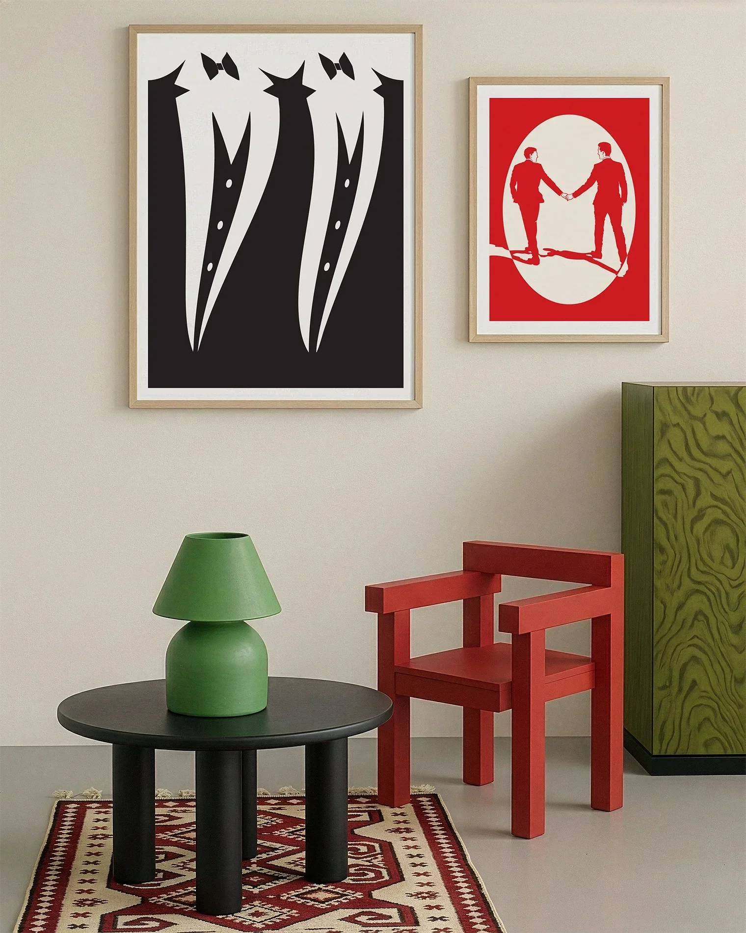 A gallery wall with several framed, queer posters in a living room.