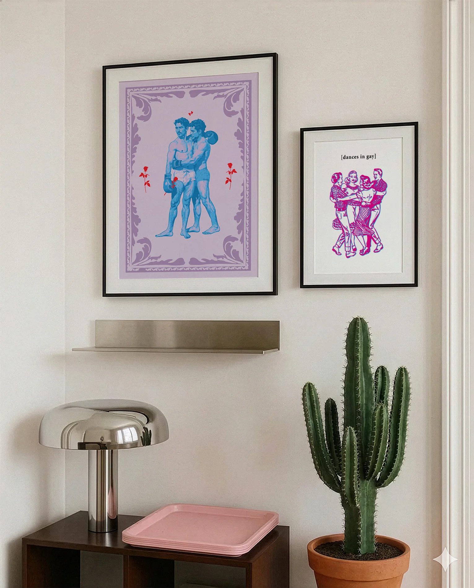 A gallery wall with several framed, queer posters in a living room.