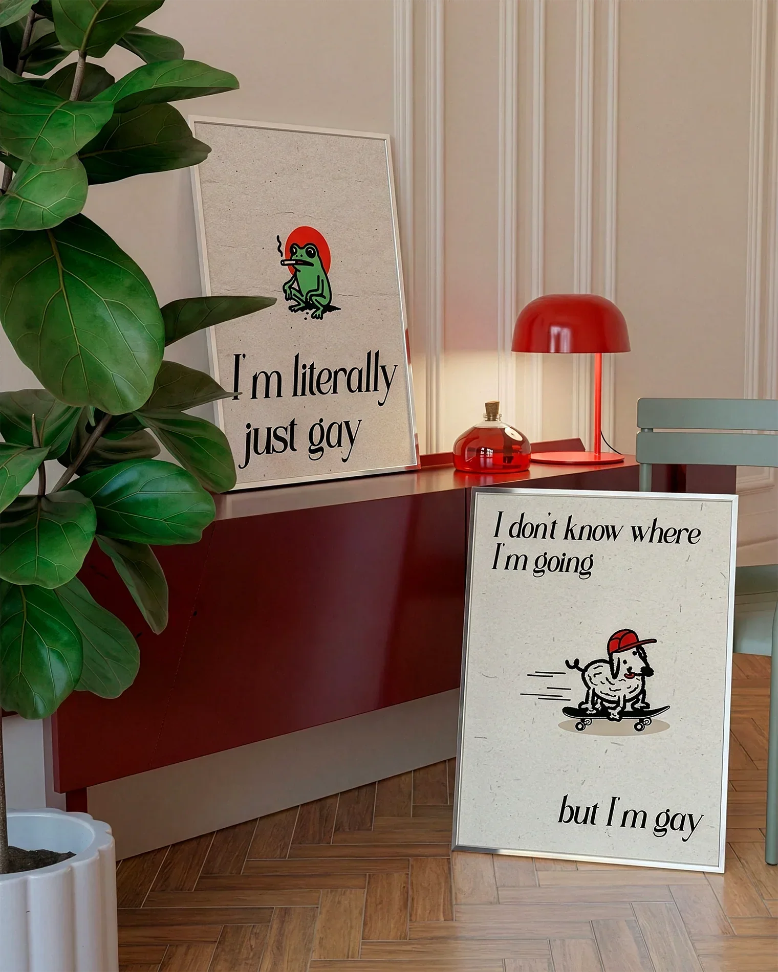 A gallery wall with several framed, queer posters in a living room.