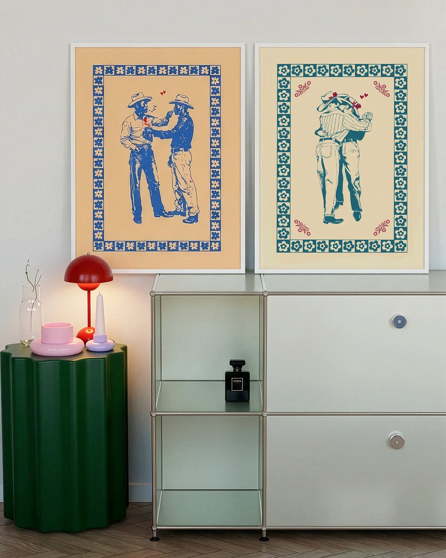 A gallery wall with several framed, queer posters in a living room.