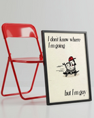 A framed poster with a cute, curly dog on a skateboard with the text 'I don't know where I'm going but I'm gay.