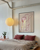 A framed print with two lesbian, naked girls hugging.