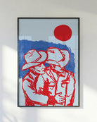 A poster with two ay cowboys hugging in front of a red sunset.