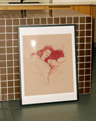 A framed poster with a lesbian couple sleeping under a blanket, sketch style.