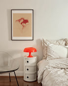 A framed poster with a lesbian couple sleeping under a blanket, sketch style.