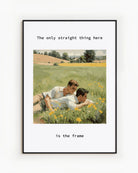 A poster with two gay men cuddling together in a summery green field of yellow flowers, with the text: “The only thing straight here is the frame.”