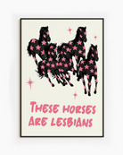 A framed poster with five horses and the text 'THESE HORSES ARE LESBIANS'.