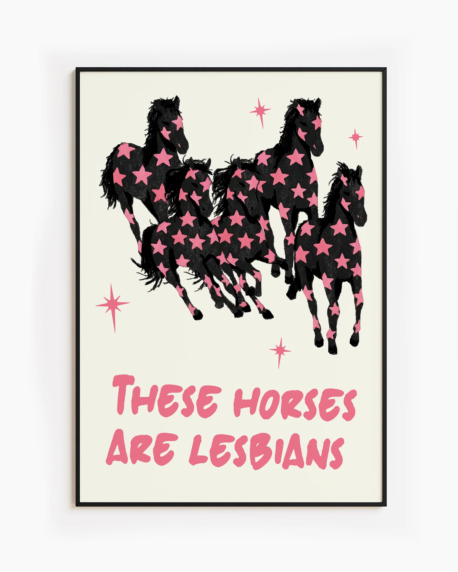 A framed poster with five horses and the text 'THESE HORSES ARE LESBIANS'.