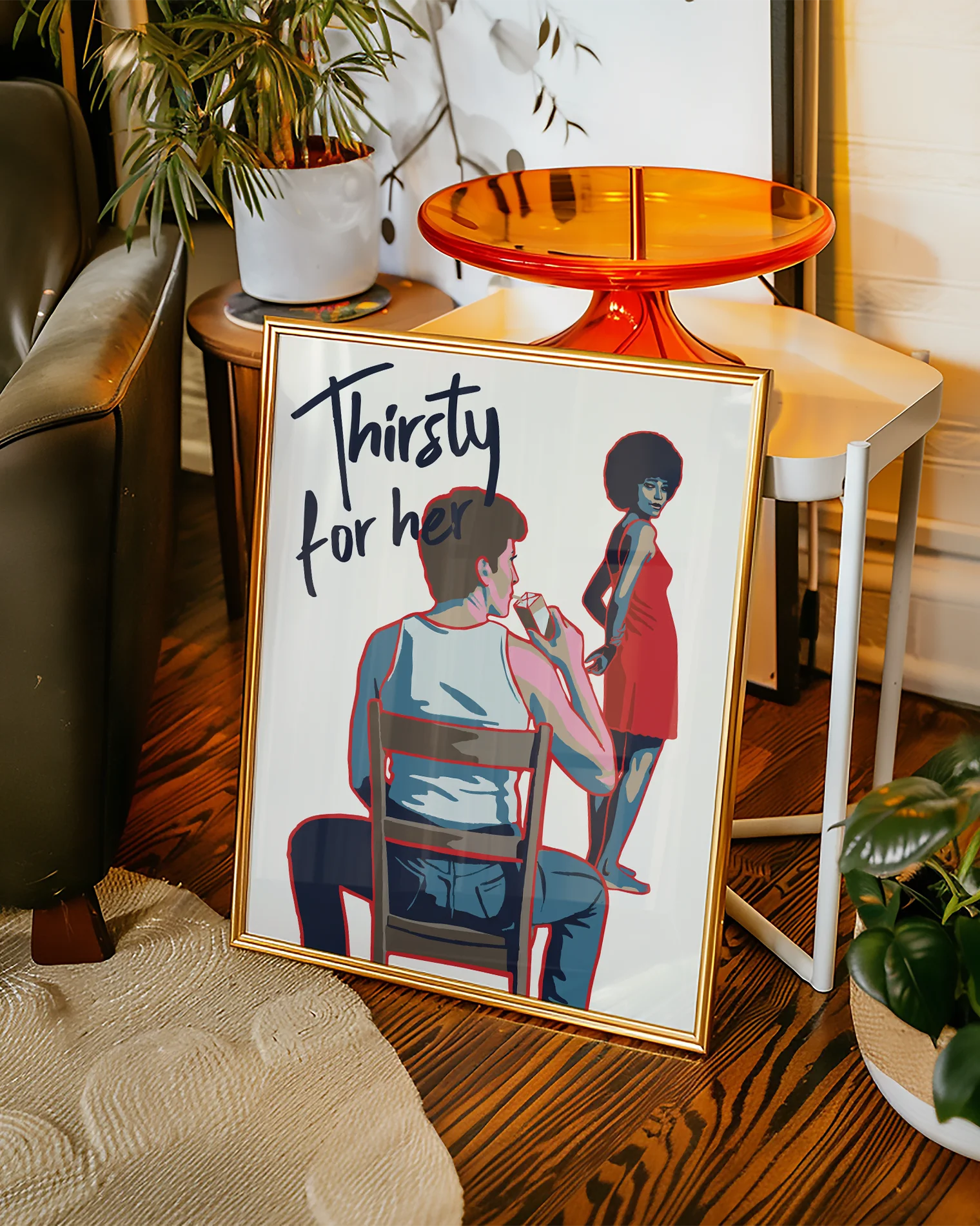 En poster som föreställer en butchflata som dricker ur en juicebox, sittandes på en stol. Framför henne står en vacker kvinna med ett sug i blicken, tillsammans med texten 'Thirsty for her'.